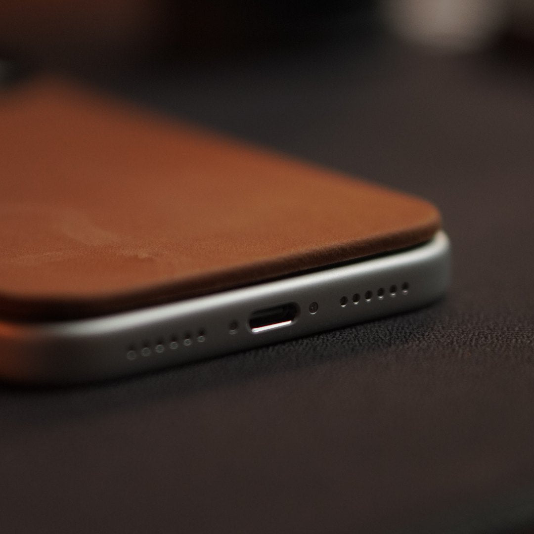 Side profile of a tan leather back on an iPhone, showing how thin it sits